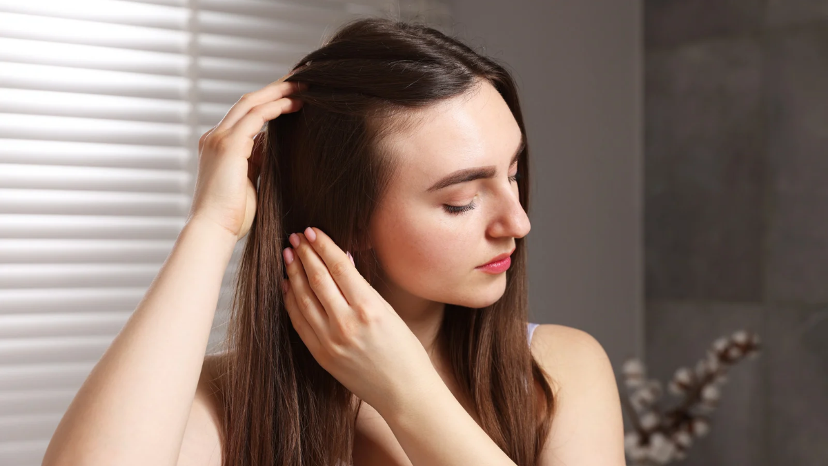 Woman caring for her hair for better results using coconut oil and egg mask