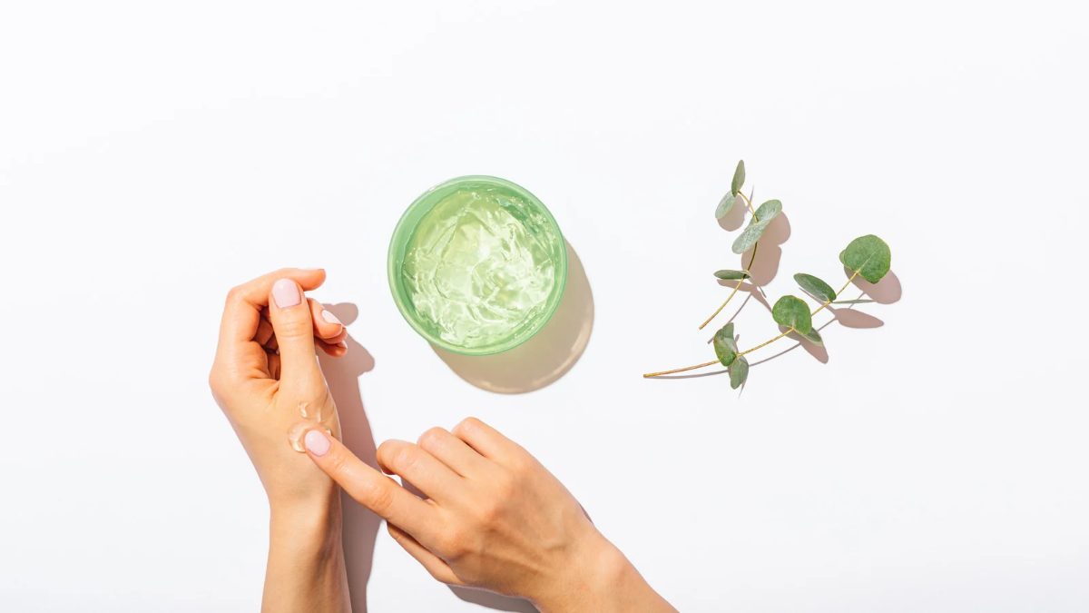 Hand applying aloe vera gel on nails to grow nails naturally and strengthen weak nails